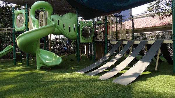 slides and climbing on fake grass